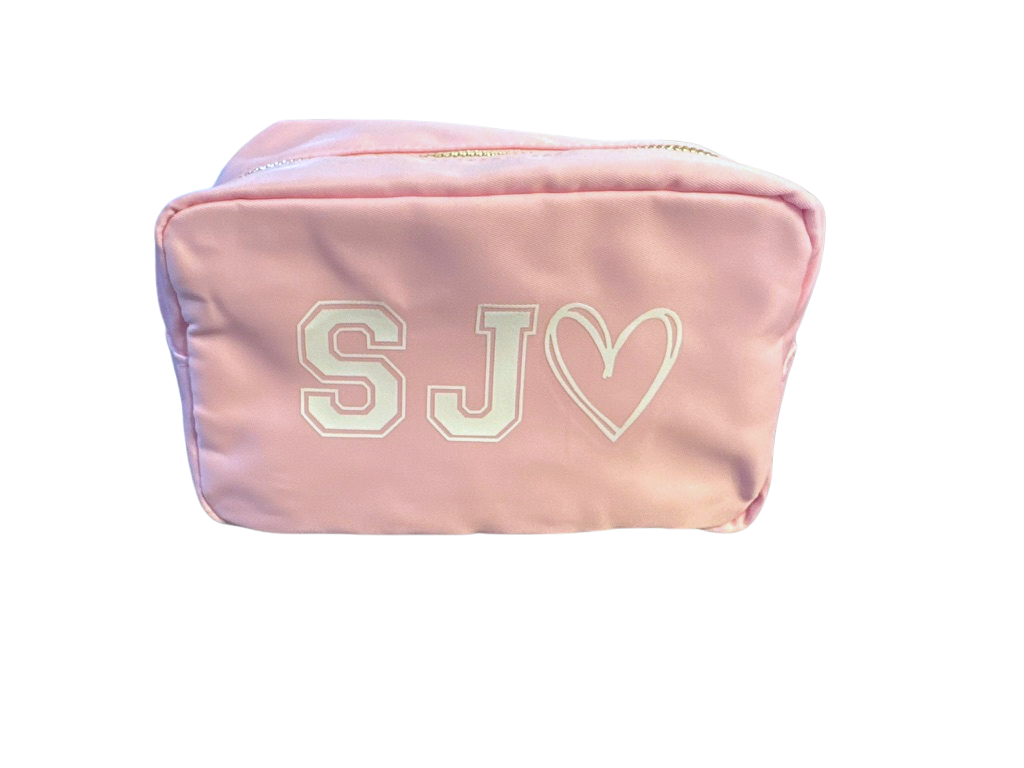 Pink pouch with 'SJ' initials and a heart
